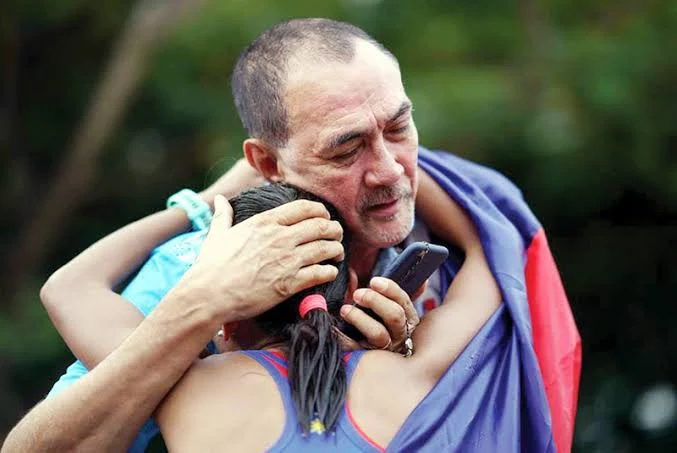 Ramon Fernandez embracing a young beneficiary