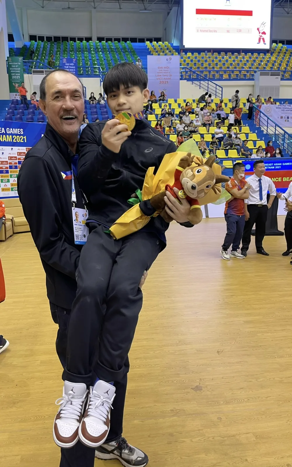 Ramon Fernandez celebrating with a gold medalist