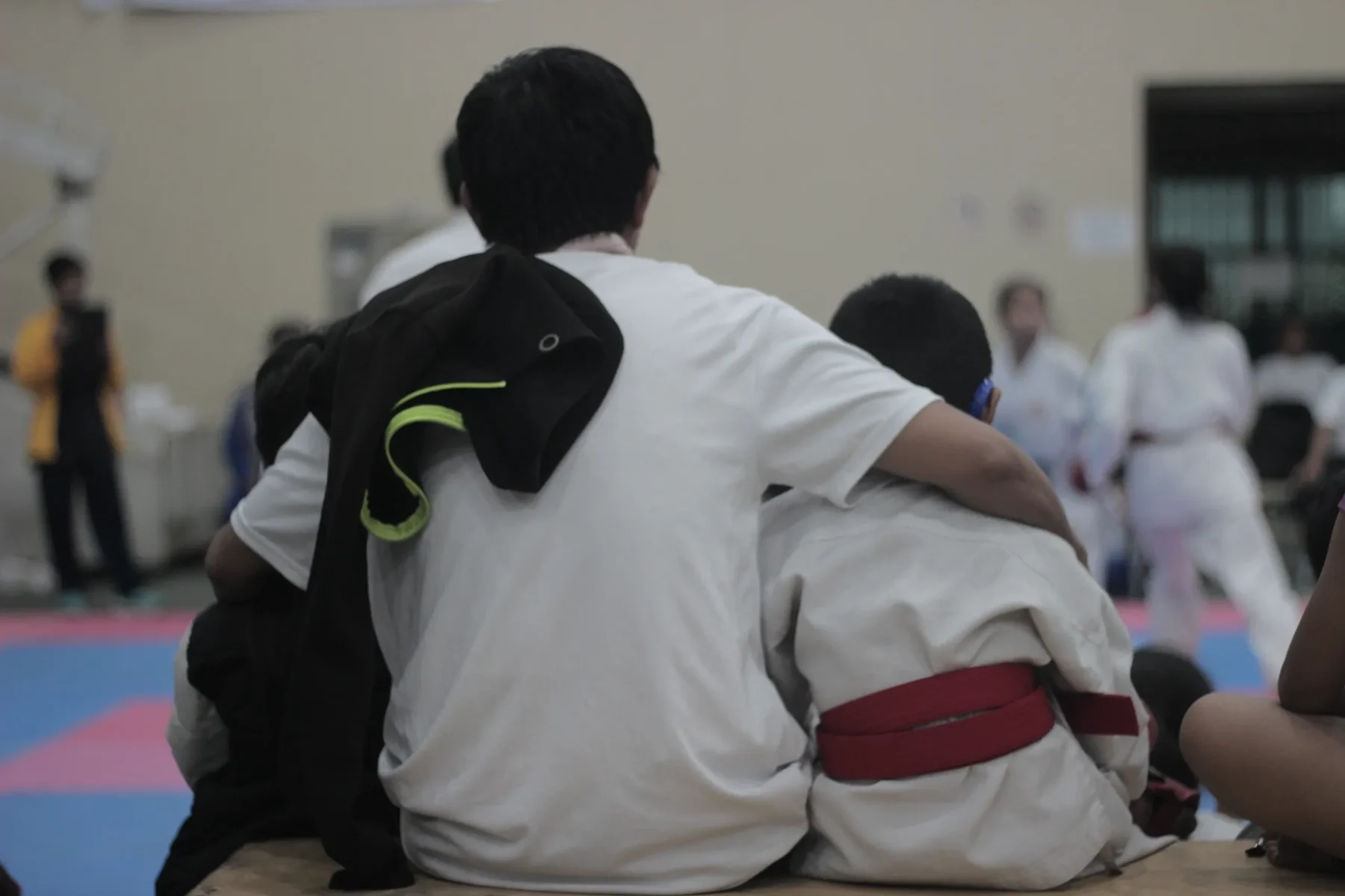 Coach supporting a young martial artist